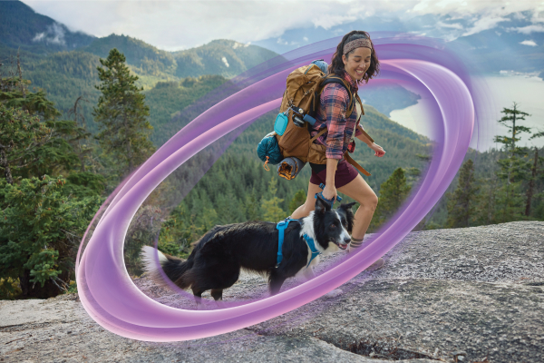 Woman hiking with her dog.